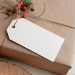 photograph of a rectangular gift wrapped in brown paper with an empty tag
