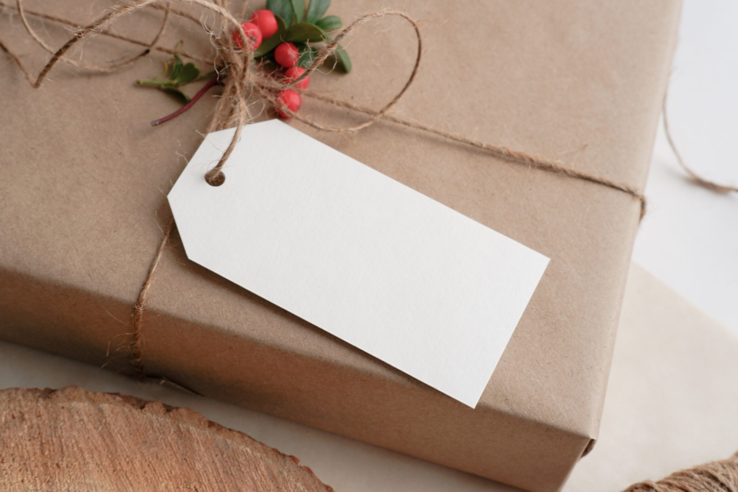 photograph of a rectangular gift wrapped in brown paper with an empty tag